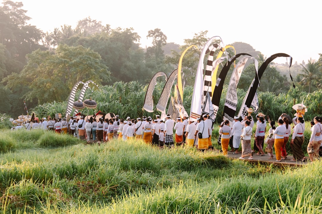 Procession of people in traditional attire with flags